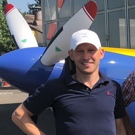 Ilja T. Gull at an airfield in front of a propeller aircraft